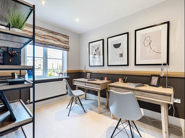 Home office featuring two desks with storage and shelves in a Persimmon house