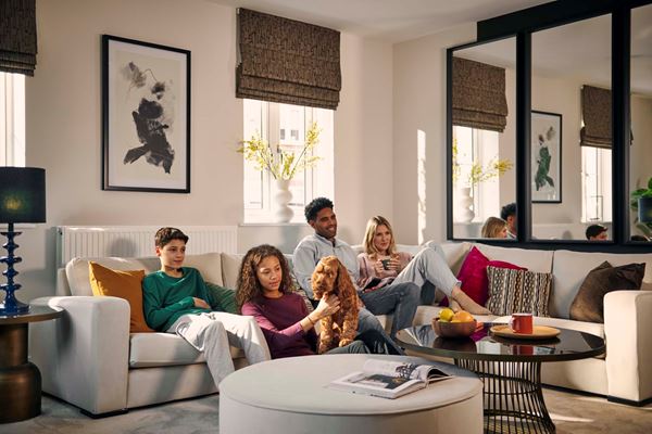 Family and dog relaxing on a white sofa in a modern living room