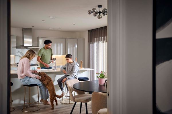 Parents and son with their dog in modern Charles Church kitchen