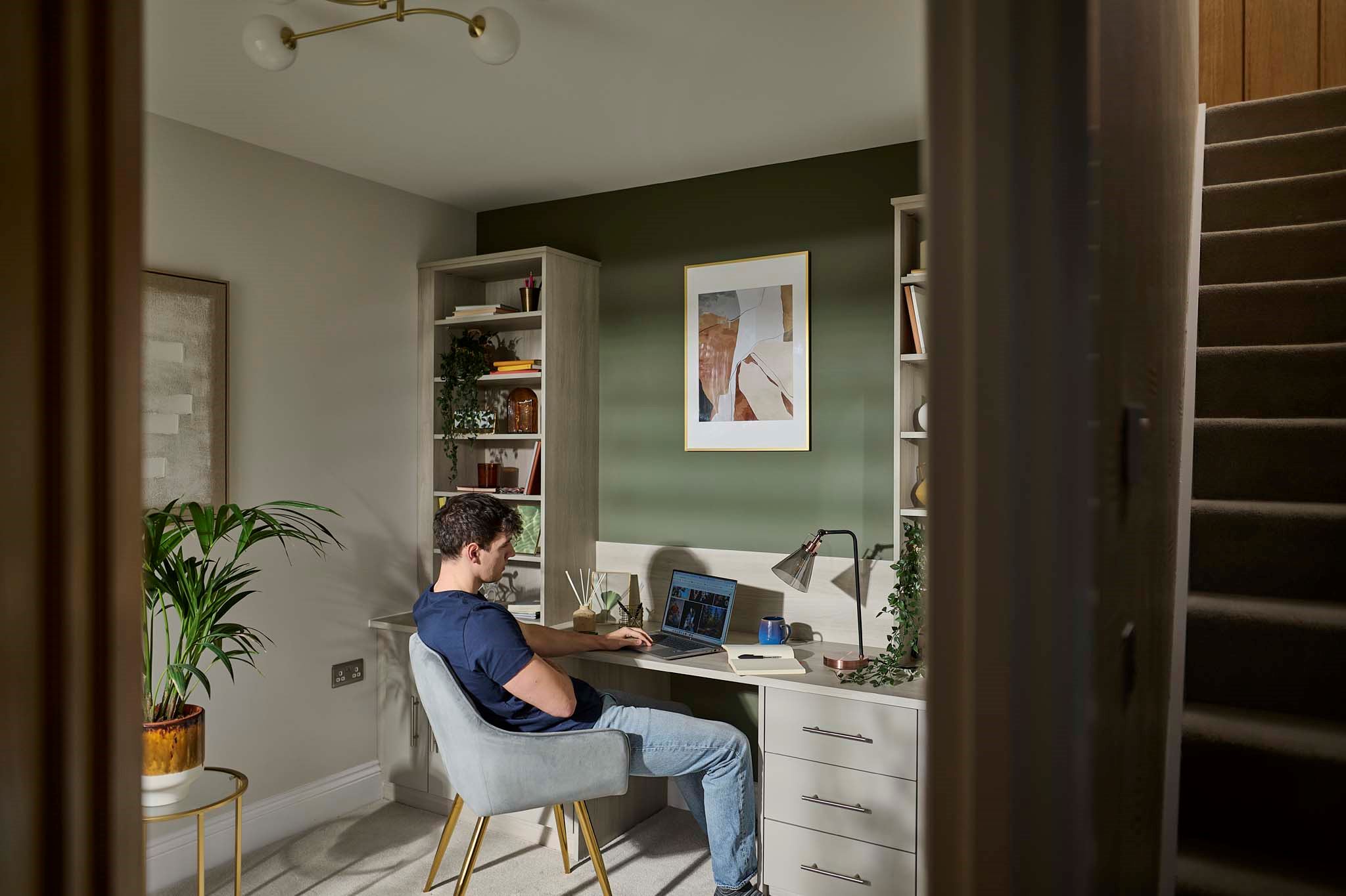 Young man sitting at desk in home office