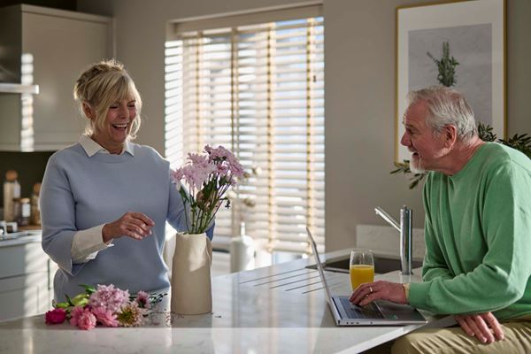 Older couple downsizing and enjoying their new kitchen in a new home by Charles Church