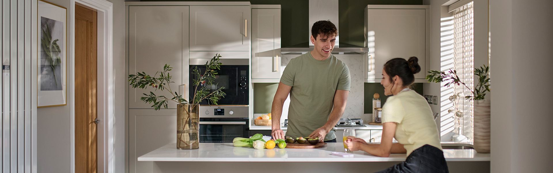 young couple laughing in a modern Charles Church kitchen
