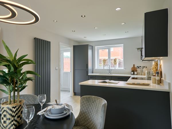 Charles Church new kitchen with minimalist style and dark cabinetry